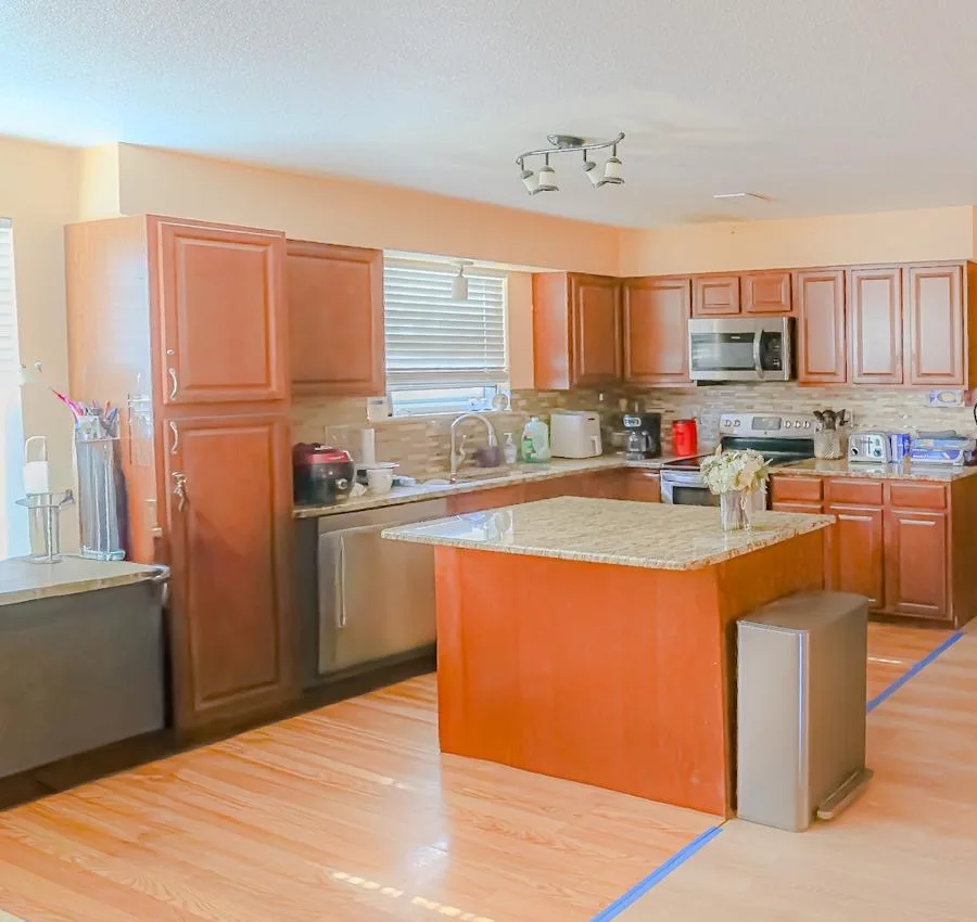 Warm wood kitchen with an open island at Rose Assisted Living